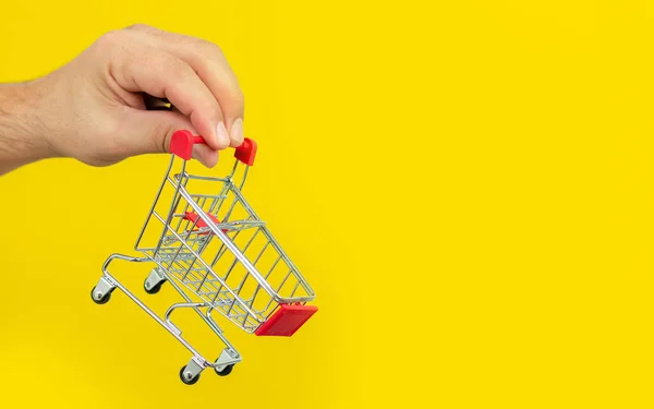 Man Holding Small Shopping Cart Trolley Trendy Yellow Background Shopping — Stock Photo, Image