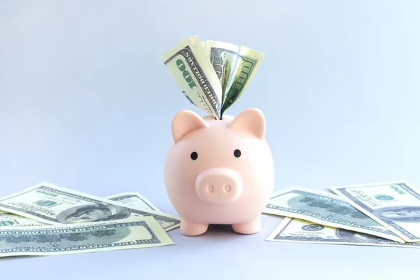 Piggy bank full of us dollar bills, deposit or savings money concept
