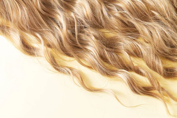 Texture of natural long blond wavy hair. Hair cut, styling, care or extension concept