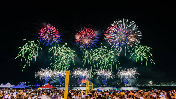 NITEROI, RIO DE JANEIRO, BRAZIL - JANUARY 2020: Night images with New Year's (Rveillon) fireworks exploding in the sky. People watch the lights and colors of the pyrotechnic celebration