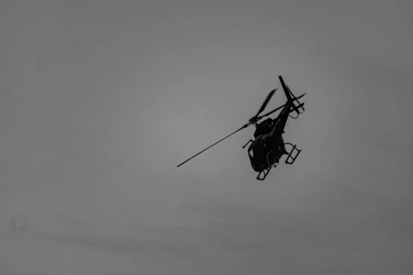 Helicopter providing air support during a Civil Police operation to combat organized crime, and drug trafficking, in a community (favela) in Rio de Janeiro, Brazil.