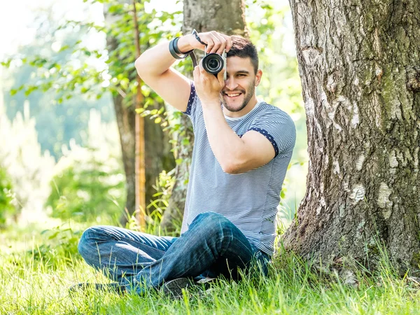 Young hipster man with camera outdoors — Stock Photo, Image