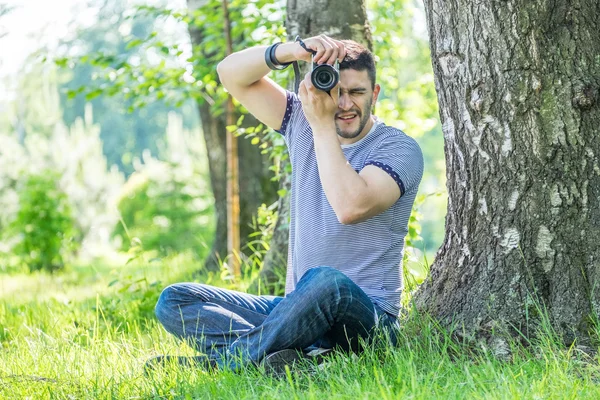 Young hipster man with camera outdoors — Stock Photo, Image