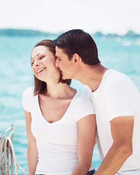 Portrait of heterosexual couple on beach water front on summer d Stok Lukisan  