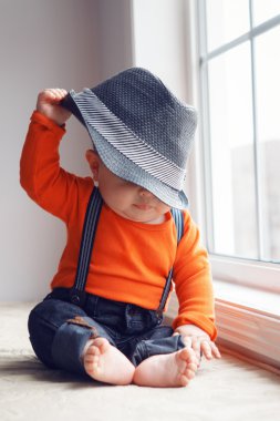 Pencere yakınında şapka sevimli bebek bebek