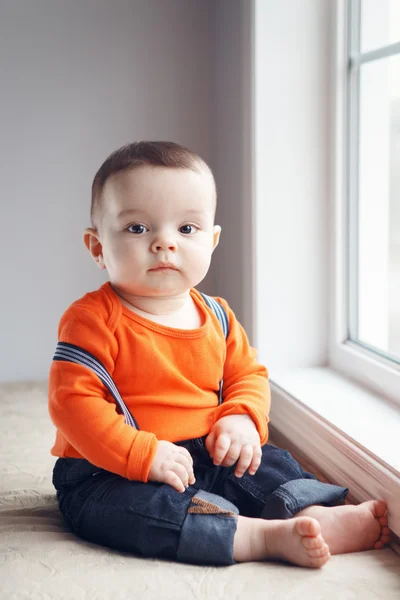 Bebê bebê bonito em chapéu perto da janela — Fotografia de Stock