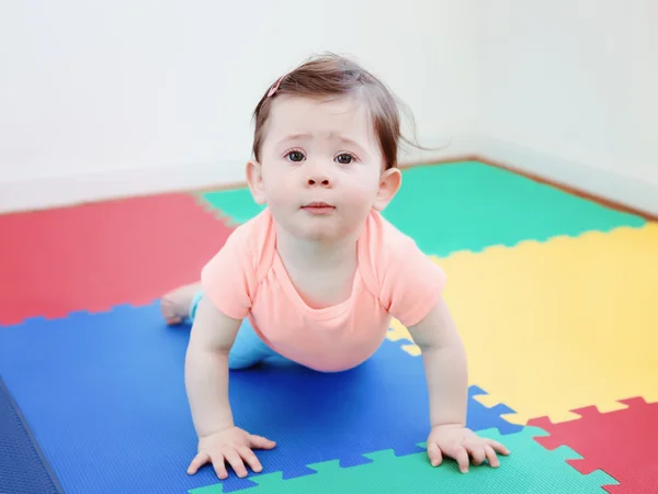 Portrait of cute adorable Caucasian smile baby boy girl lying on floor in kids room looking in camera, natural window light, lifestyle — Stok Foto