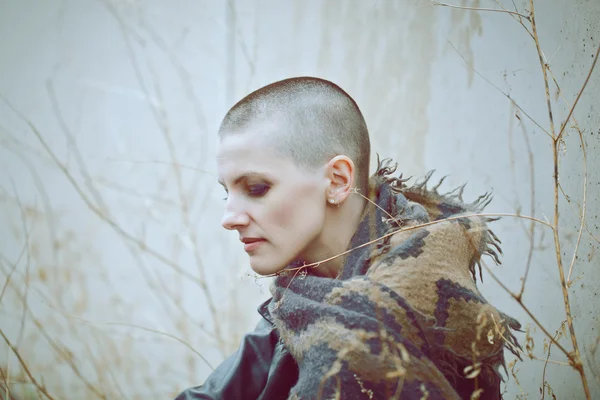 Portrait of sad beautiful Caucasian white young bald girl woman with shaved hair head in leather jacket and scarf shaw looking away, toned with Instagram filters in blue green color — Stock Photo, Image