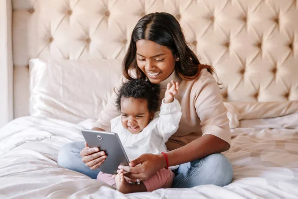 Mixed Race Indian Black Mother Toddler Baby Girl Watching Cartoons Stock Image