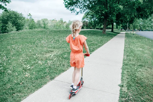Νεαρό Κορίτσι Κόκκινο Πορτοκαλί Romper Ιππασία Σκούτερ Στο Δρόμο Πάρκο — Φωτογραφία Αρχείου