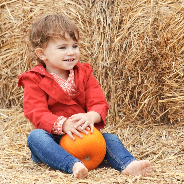 Baby with pumpkins on a farm — Stock Photo, Image