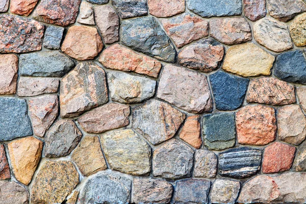 Colored stones in grey wall — Stock Photo, Image