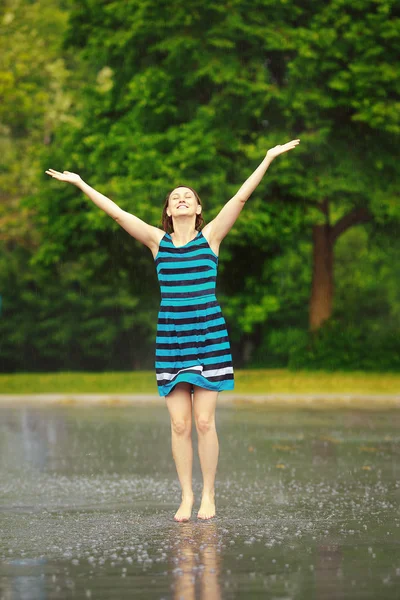 Girl jumping under the rain — Stock Photo, Image