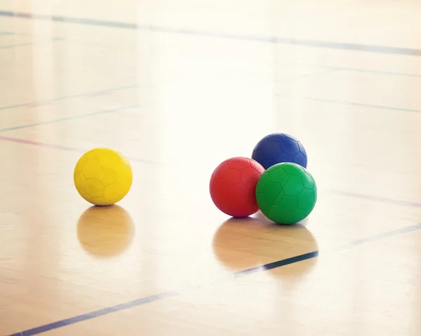 Set of colorful balls on gym floor — Stock Photo, Image