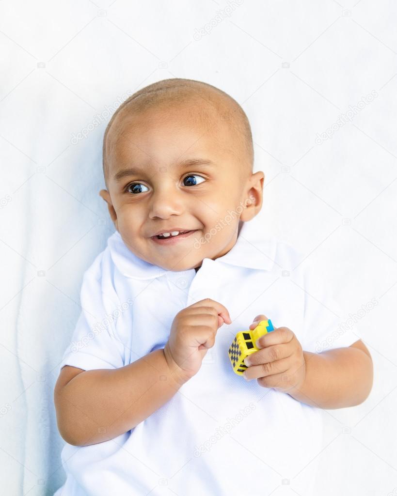 Portrait of indian baby boy with toy