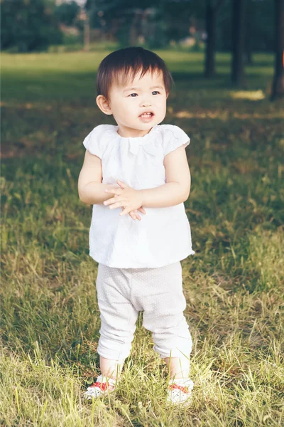 Portrait of asian baby clapping her hands — стокове фото