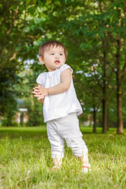 Portrait of cute Asian child clapping her hands
