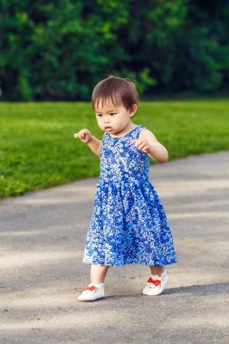 Portrait of cute Asian child playing in park