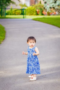 Portrait of cute Asian child playing in park