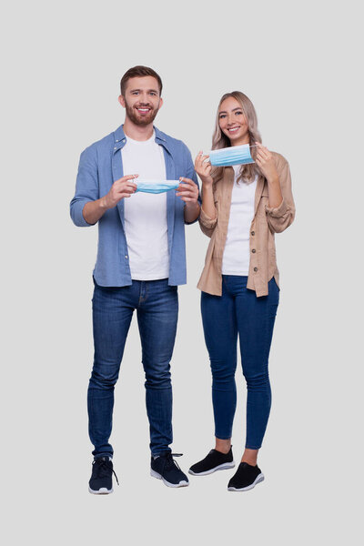 Couple Puts on Medical Mask Standing Isolated. Health protection, Medical Care, Couple, Family Concept. Virus