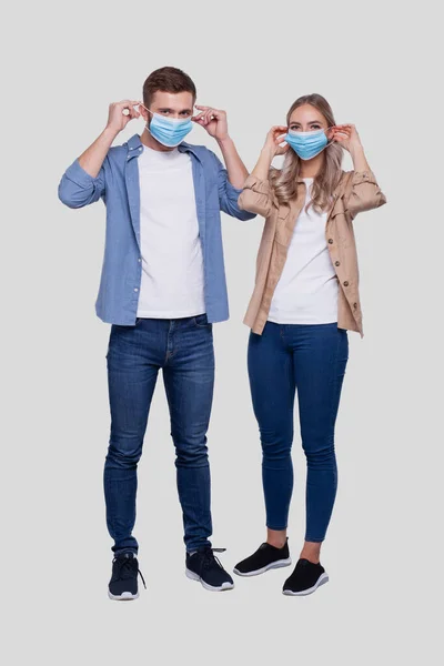 Par Sätter Medicinsk Mask Stående Isolerad Hälsoskydd Sjukvård Par Familjebegreppet — Stockfoto