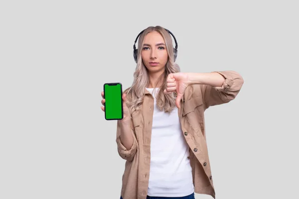 Girl Listening Music Phone Showing Thumb Girl Pointing Phone Green — Stock Photo, Image