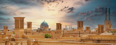 Panoramic view of badgirs and mosques of Yazd on a cloudy day, in Iran clipart