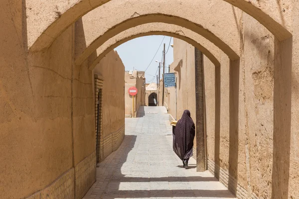 Mujer camina por las estrechas calles de Yazd en Irán — Foto de Stock