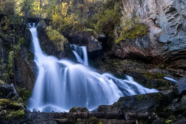 A small waterfall on a mountain river in the Altai. The Altai Mountain Rivers.