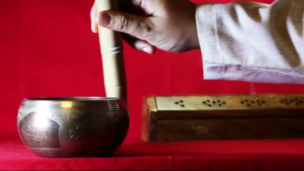 Tibetan singing bowl on the red background. With sound — Stock Video