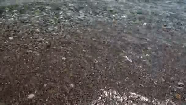 Background of Transparent waves of the sea run over on the beautiful pebble beach — Stock Video