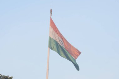 India flag flying high at Connaught Place with pride with plain white background, India flag fluttering, Indian Flag on Independence Day and Republic Day of India, tilt up shot, Har Ghar Tiranga