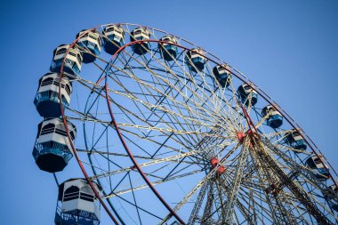 Delhi, Hindistan 'da Dussehra Mela sırasında çok renkli Dev Tekerlek' in yakın çekimi. Dev tekerlek salıncağının alt görüntüsü. Akşam vakti renkli kamaraları olan dönme dolap..