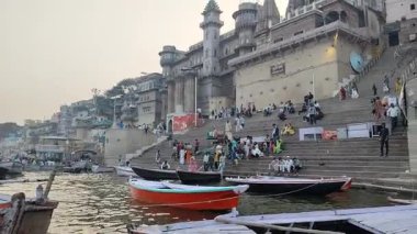 Varanasi, India - March 23 2025 - World famous various Ganga Ghats view from motor boat running in Ganga river, Spiritual Ganga Ghat view during evening time at old Varanasi city