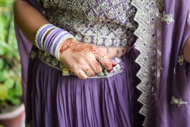 Hint geleneği gibi giyinmiş güzel bir kadın. İki elinde de Henna Mehndi tasarımı var. Hintli bir kadının kocası için Karwa Chauth ve Karwa Chauth kutlamalarını kutlamak için.