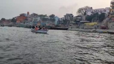 Varanasi, India - March 23 2025 - World famous various Ganga Ghats view from motor boat running in Ganga river, Spiritual Ganga Ghat view during evening time at old Varanasi city