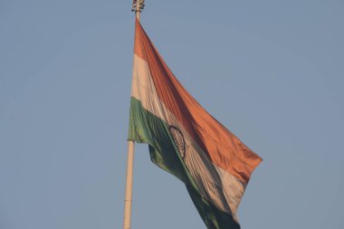 India flag flying high at Connaught Place with pride with plain white background, India flag fluttering, Indian Flag on Independence Day and Republic Day of India, tilt up shot, Har Ghar Tiranga