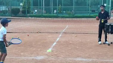 Delhi, Hindistan, 17 Şubat 2025 - Maha Open için kil tenis kortunda antrenörlük yapan genç tenisçiler, yaklaşan turnuva için küçük tenis oyuncuları antrenman yapıyor