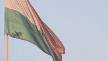 India flag flying high at Connaught Place with pride with plain white background, India flag fluttering, Indian Flag on Independence Day and Republic Day of India, tilt up shot, Har Ghar Tiranga
