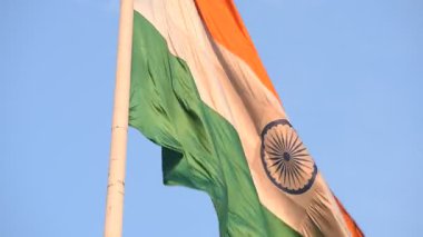 India flag flying high at Connaught Place with pride with plain white background, India flag fluttering, Indian Flag on Independence Day and Republic Day of India, tilt up shot, Har Ghar Tiranga