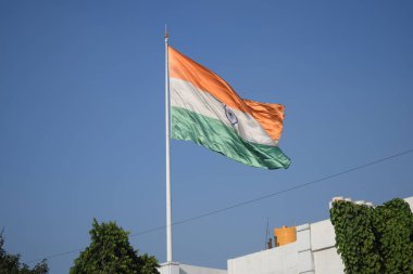 India flag flying high at Connaught Place with pride with plain white background, India flag fluttering, Indian Flag on Independence Day and Republic Day of India, tilt up shot, Har Ghar Tiranga