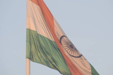 India flag flying high at Connaught Place with pride with plain white background, India flag fluttering, Indian Flag on Independence Day and Republic Day of India, tilt up shot, Har Ghar Tiranga