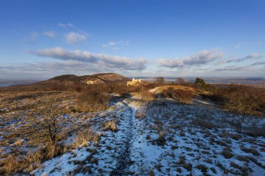 Sirotci hradek ve Palava tepesinin kış panoramik manzarası, mavi gökyüzünün altındaki karla kaplı çayır, Güney Moravya, Çek Cumhuriyeti