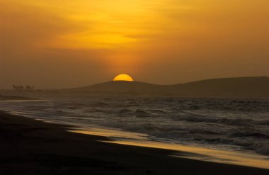 Sun setting behind the great dune of Jericoacoara beach, near Fortaleza, Ceara State, Brazil on April 23, 2005. clipart