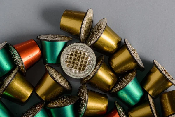 Colored and used coffee capsules in close-up.