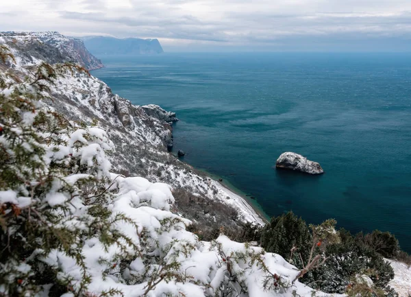 Winter sunset over the sea bay from the height of overhanging cliffs. Cape Fiolent in Balaklava, Sevastopol, Crimea.The concept of calm, silence and unity with nature