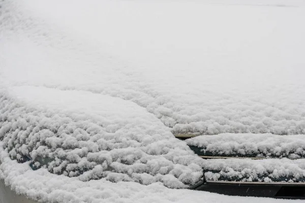 Snow covered car. Fresh snow on car in cold winter morning. Concept of driving in winter time with snow on road. Winter season. Copy space.