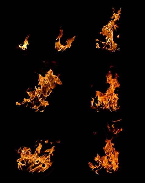 Яскраве полум'я в вогнищі на чорному фоні фото — стокове фото