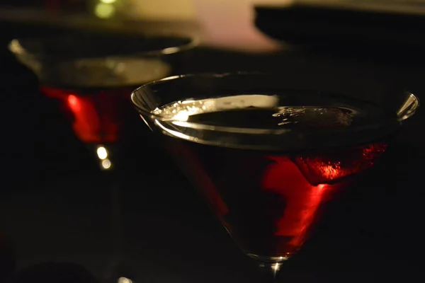 Red alcohol cocktail in triangular glasses for a couple celebrating romantic night — Stock Photo, Image