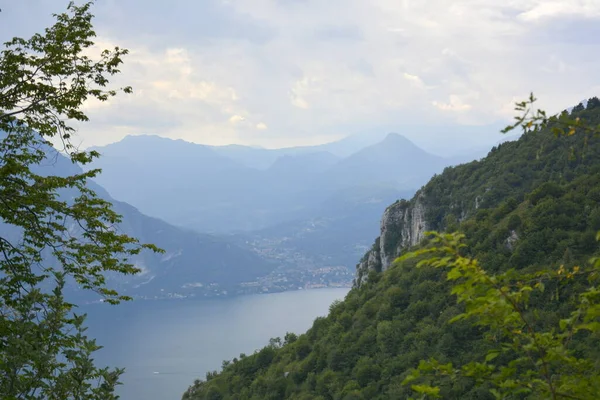 Panorama of mountain lake Como surrounded by green hills covered with cedar forest — Stock Photo, Image
